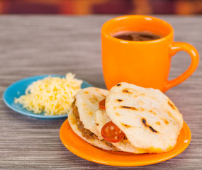 Traditional delicious arepas, shredded chicken avocado and cheddar cheese and shredded beef