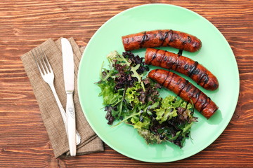Grilled sausages with greens
