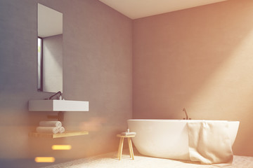 Fototapeta na wymiar Gray bathroom with sink and tub, toned
