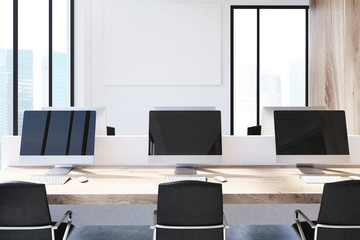 Table with three computer monitors