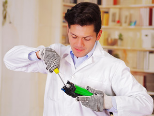 closeup shot young male technician repairing a toner using a screwdriver
