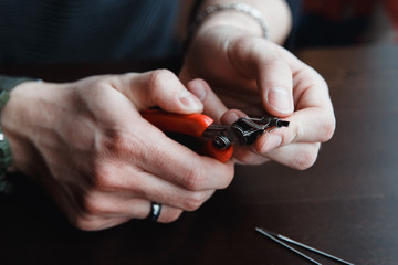 male master installs a coyle. Spiral for electronic evaporator and cigarette. Vape, vaping