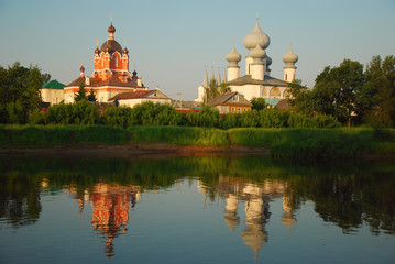 old orthodox church near a lake water shore