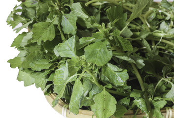 Amaranth leaves in basket, isolated on white background