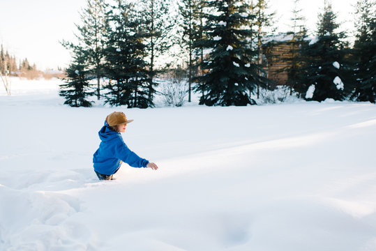 Boy playing in snow in winter