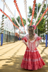 Girl in traditional flamenco dresses dance during the Feria de Abril on April