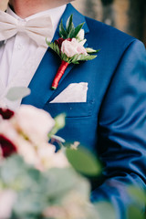 groom's boutonniere with roses