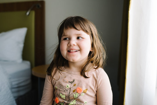 Little girl smiling in bedroom