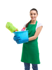 Young woman holding bucket with cleaning supplies on white background