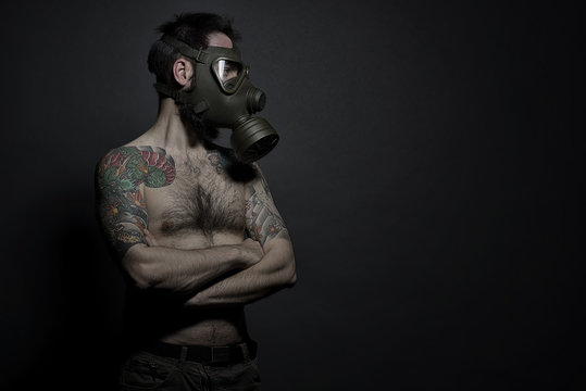 Hipster tatuato con maschera anti gas