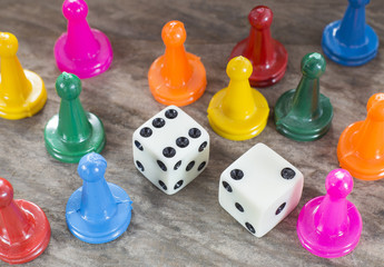 Game pieces with dices on slate