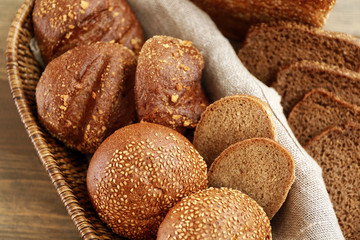 Wicker basket with different buns on table