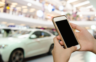 Woman using mobile smartphone at motor show event