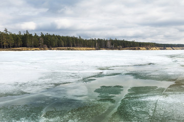 The coast of the Ob river with melting ice
