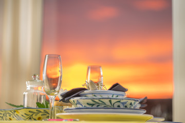 diner at sunset with wine in glass