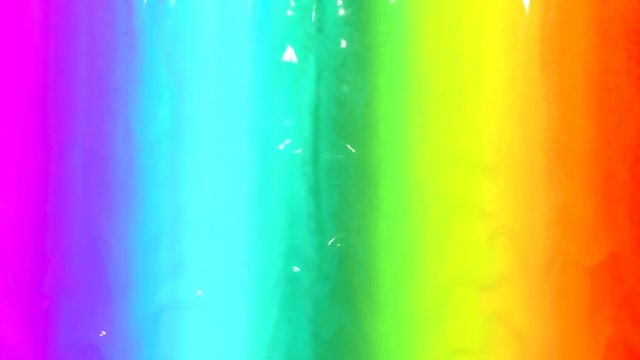 4k bright rainbow paint cascades down wall with love text popping out towards the end.