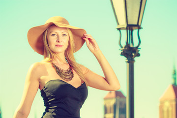 Portrait of fashionable woman wearing big sun hat