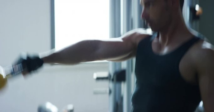 Guy bodybuilder in the gym, works with a barbell, bench press, improving triceps, large pectorals muscle, anterior deltoids muscle Concept love sports, go to the gym, eat right, slim body, be healthy.