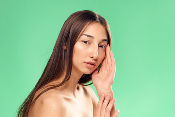 woman, green background, brunette with a gentle face...