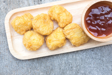 Chicken nuggets on a wooden plate