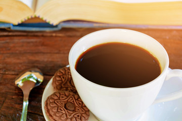 coffee cup and clock on old wood table