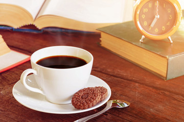 coffee cup and clock on old wood table