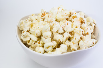 Popcorn in white bowl closeup image white background