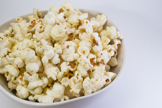 Popcorn in white bowl closeup image white background