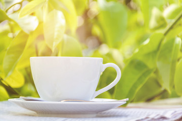 coffee cup clock and news paper on old wooden table