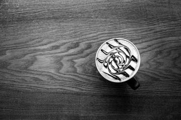 Coffee cup on wooden background.Black and white film tone, Top  view.