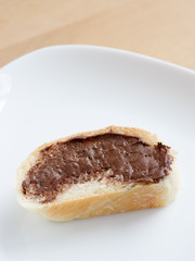 Piece of french bread with chocolate peanut butter