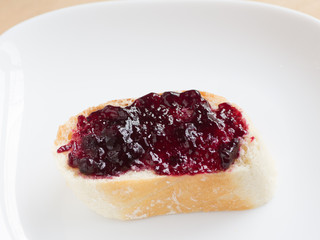 Piece of french bread wit blueberry jam
