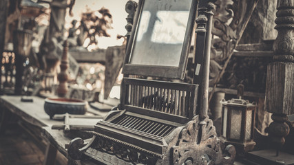 Antique makeup mirror with stand and black wood edge.