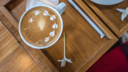 Hot coffee latte with heart shaped foam art.