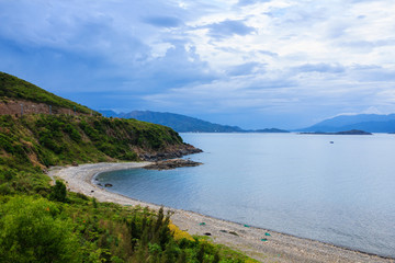 Fototapeta na wymiar Nha Trang bay, Vietnam. View from Pham Van Dong (657) highway. Nha Trang is well known for its beaches and scuba diving and has developed into a destination for international tourists.