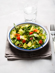 Healthy avocado spinach tomato salad. Gourmet dieting