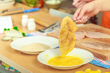 Preparing meal of breaded chicken cutlets