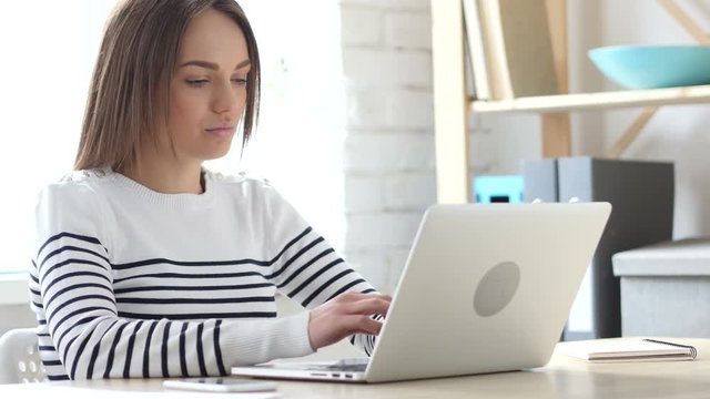 Beautiful Woman Working On Laptop in Office