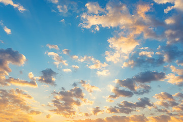 Dramatic sky background include sunset or sunrise, abstract cloud look fluffy. Represent weather, wind, heaven, freedom and god. Colorful with yellow, orange and blue color at evening in autumn. 