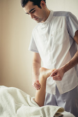 Fototapeta premium Physical Therapist giving a leg massage for little girl