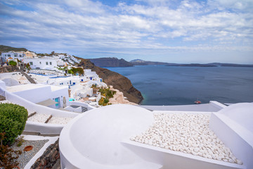 Obraz premium Oia town on Santorini island, Greece. Traditional and famous houses and churches with blue domes over the Caldera, Aegean sea