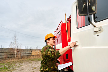 Fototapeta premium Portrait of a man, a firefighter, an Asian-Kazakh at work
