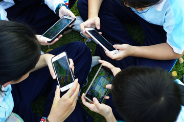 Group of student playing game on smartphone.