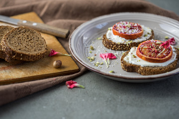 Sandwich with red orange and cottage cheese on a white plate, a close up with copy space