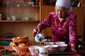 Kazakh grandma pours tea