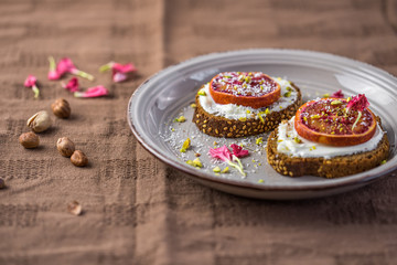 Sandwich with red orange and cottage cheese on a white plate, a close up with copy space