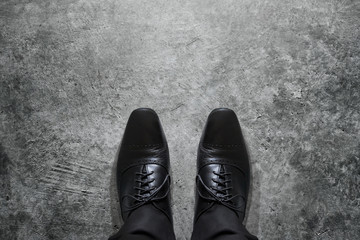 Black formal shoes of businessman, top view