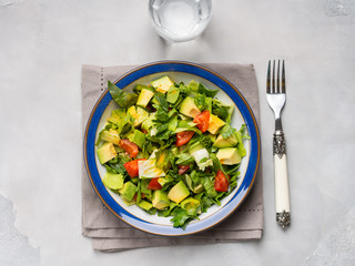 Healthy avocado spinach tomato salad. Gourmet dieting
