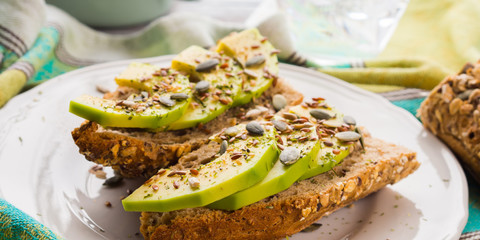 Avocado cereal sandwich for healthy snack with seeds on green napkin