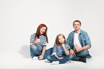 Happy family portrait sitting on white background isolated